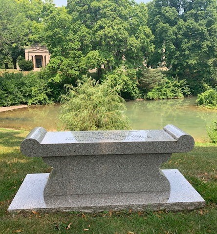 memorial sitting bench by pond
